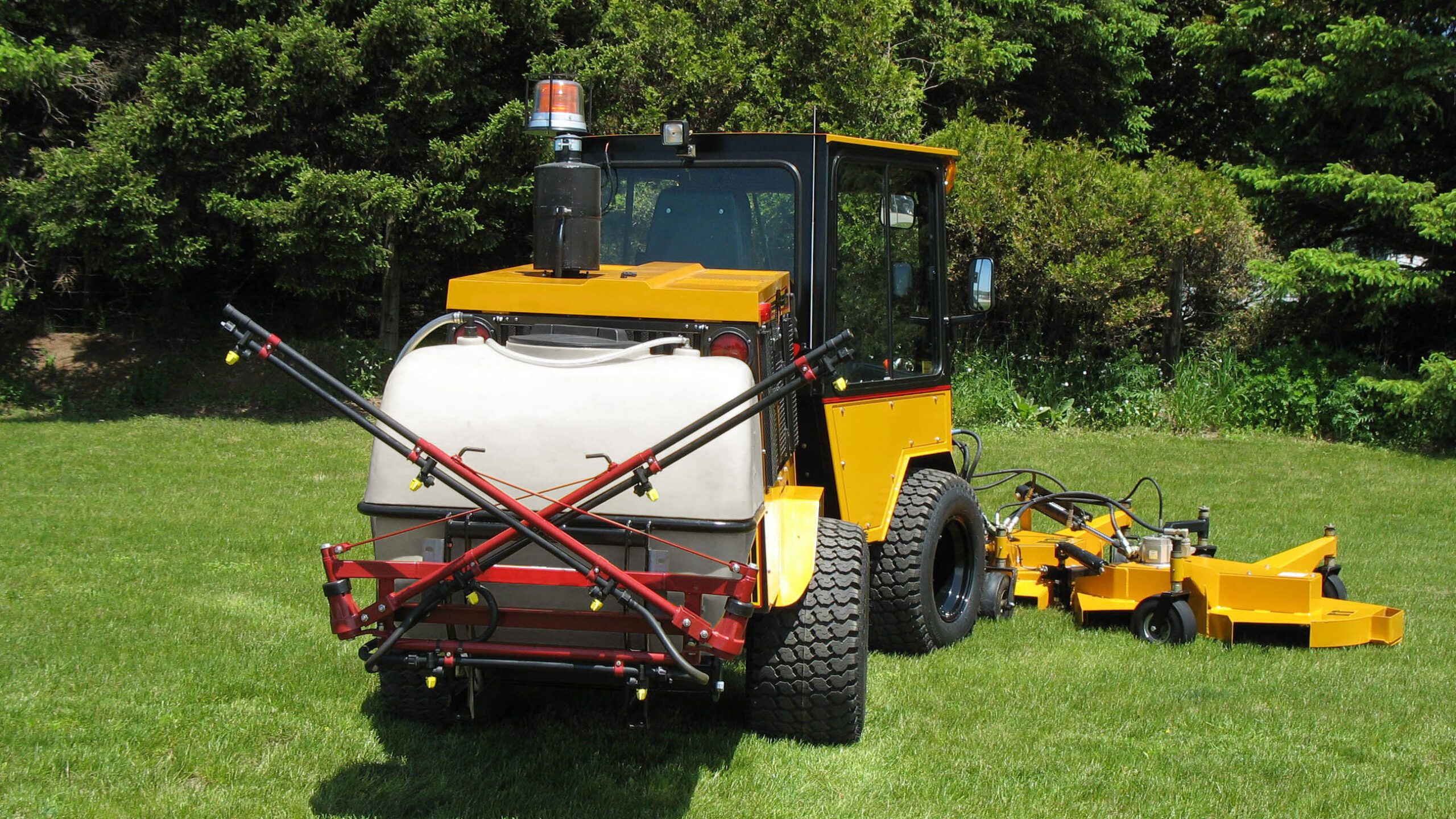 trackless vehicles mt6 tractor machine with rotary mower attachment, 80 gallon water tank attachment and spray bar attachment