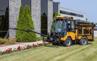 trackless vehicles mt7 machine and spray arm attachment with watering head watering flowers in flower bed