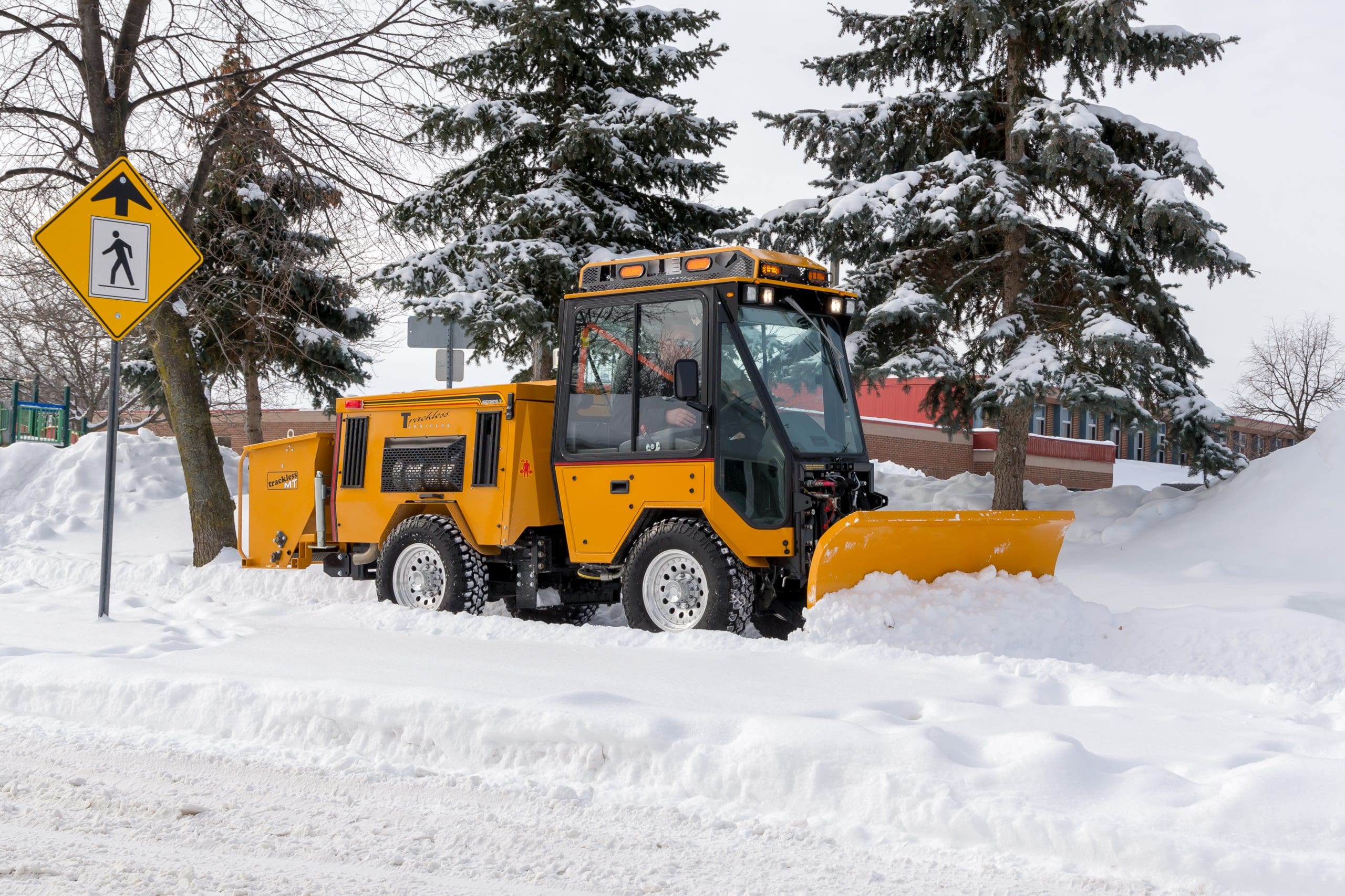 trackless vehicles angle snowplow attachment on sidewalk municipal tractor