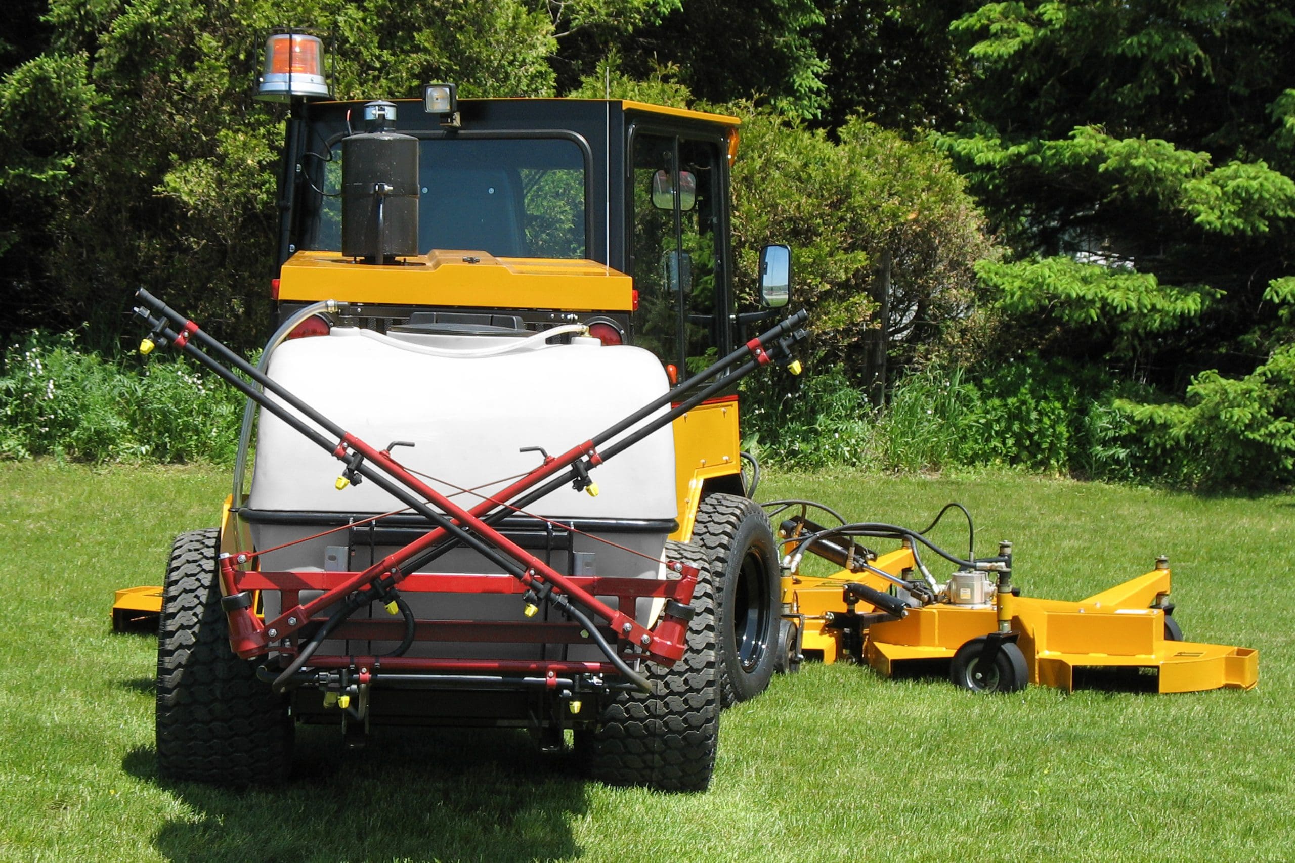 trackless vehicles spraying system attachment on sidewalk municipal tractor