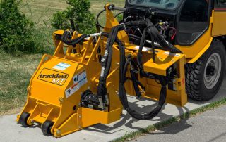 trackless vehicles cold planer attachment on sidewalk tractor close-up front view