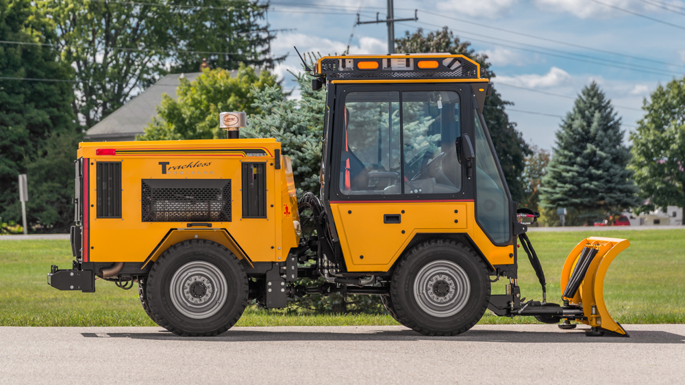 trackless vehicles angle snowplow attachment on sidewalk tractor side view