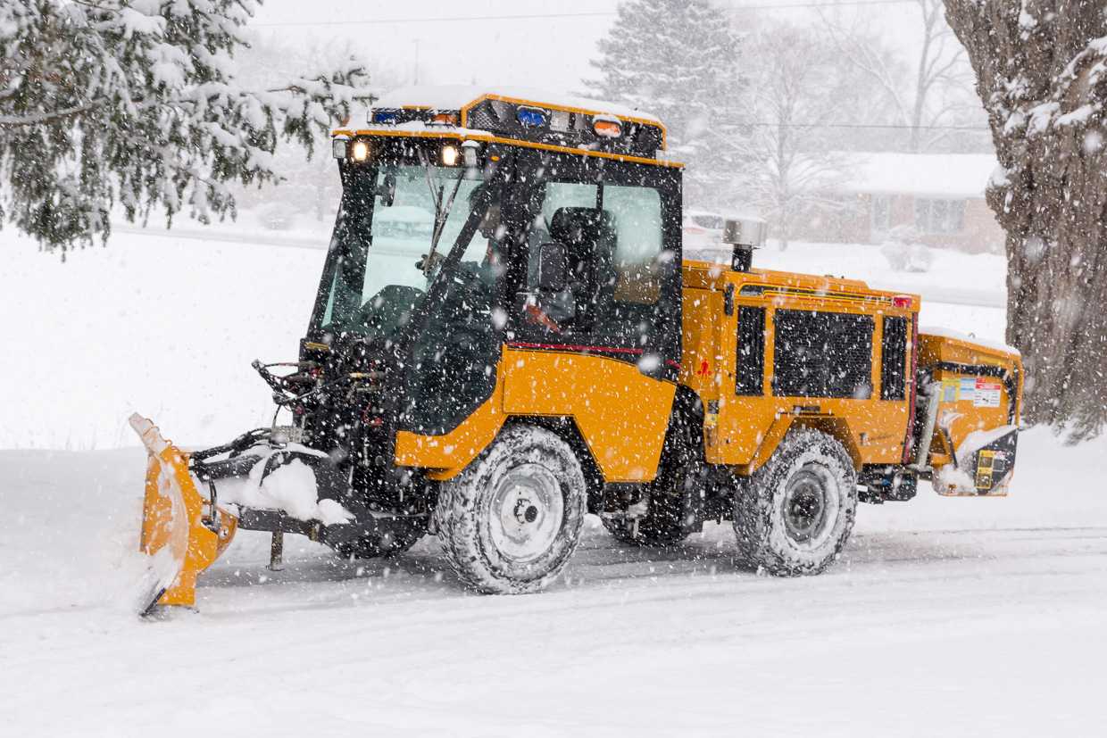 trackless vehicles 5-position folding v-plow attachment on sidewalk tractor in snow side view