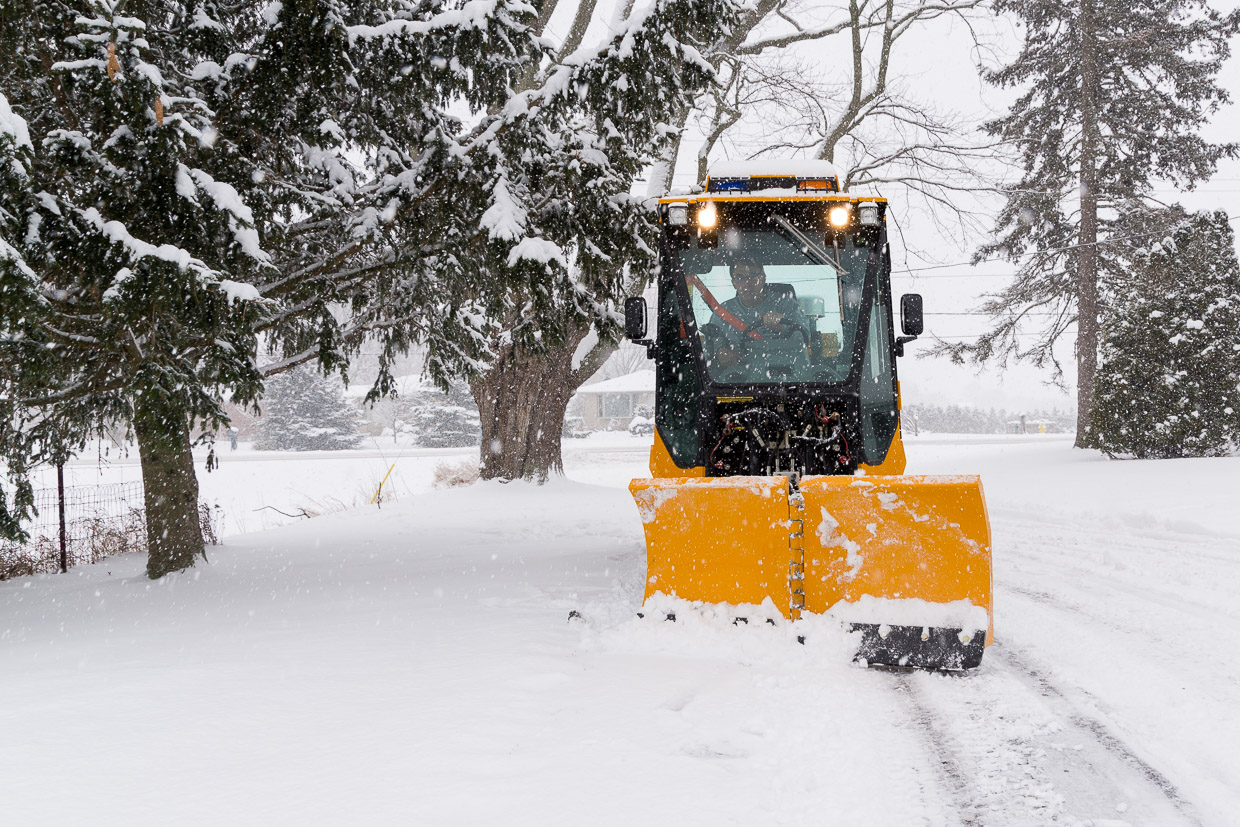 trackless vehicles 5-position folding v-plow attachment on sidewalk tractor in snow front view