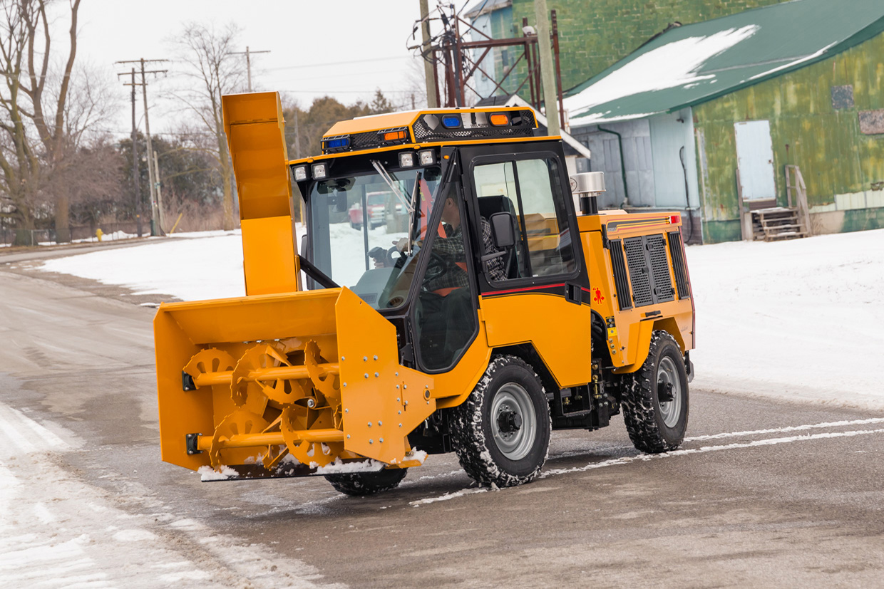 trackless vehicles twin auger snowblower on road